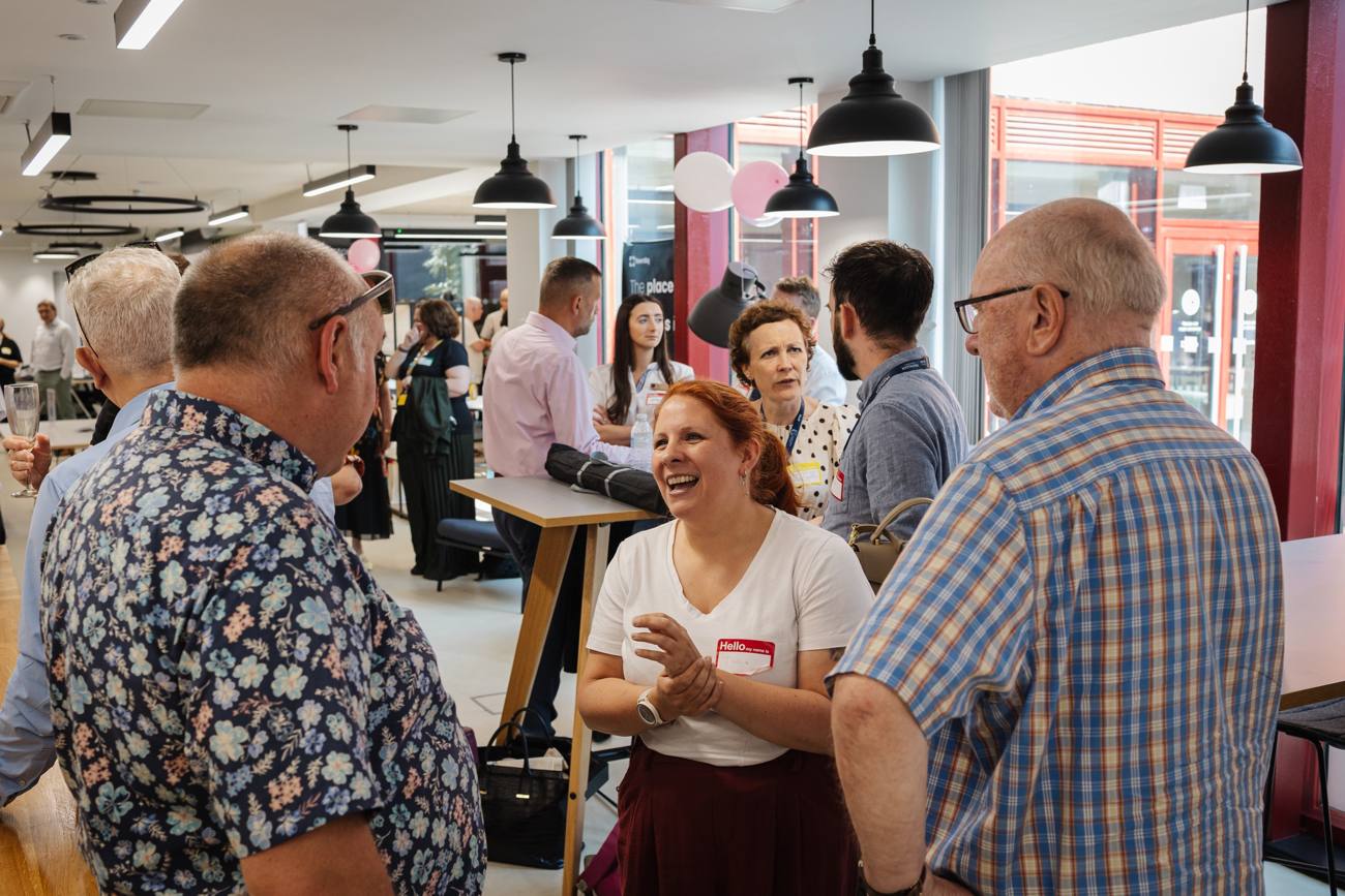 People chatting and laughing at a TownSq networking event